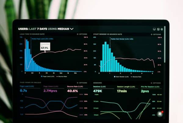 analytics charts on dual computer monitors