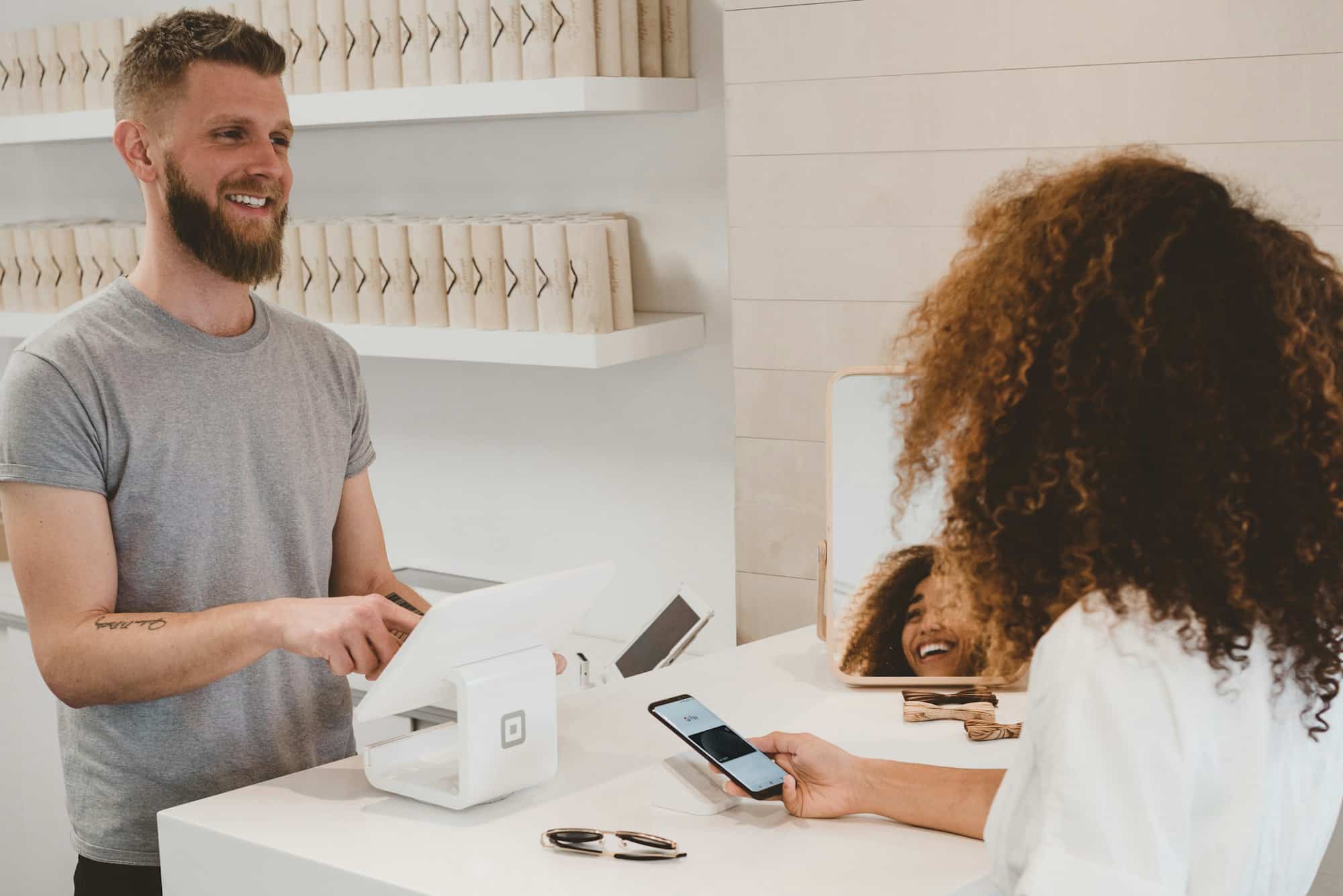 Customer paying at a retail checkout counter